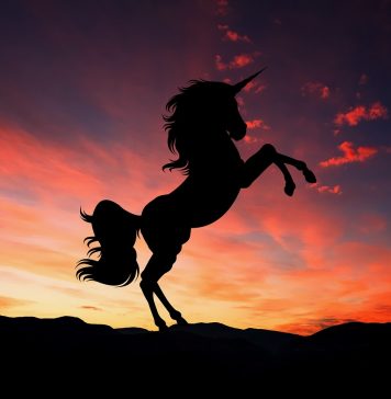 silhouette of a unicorn against twilight sky